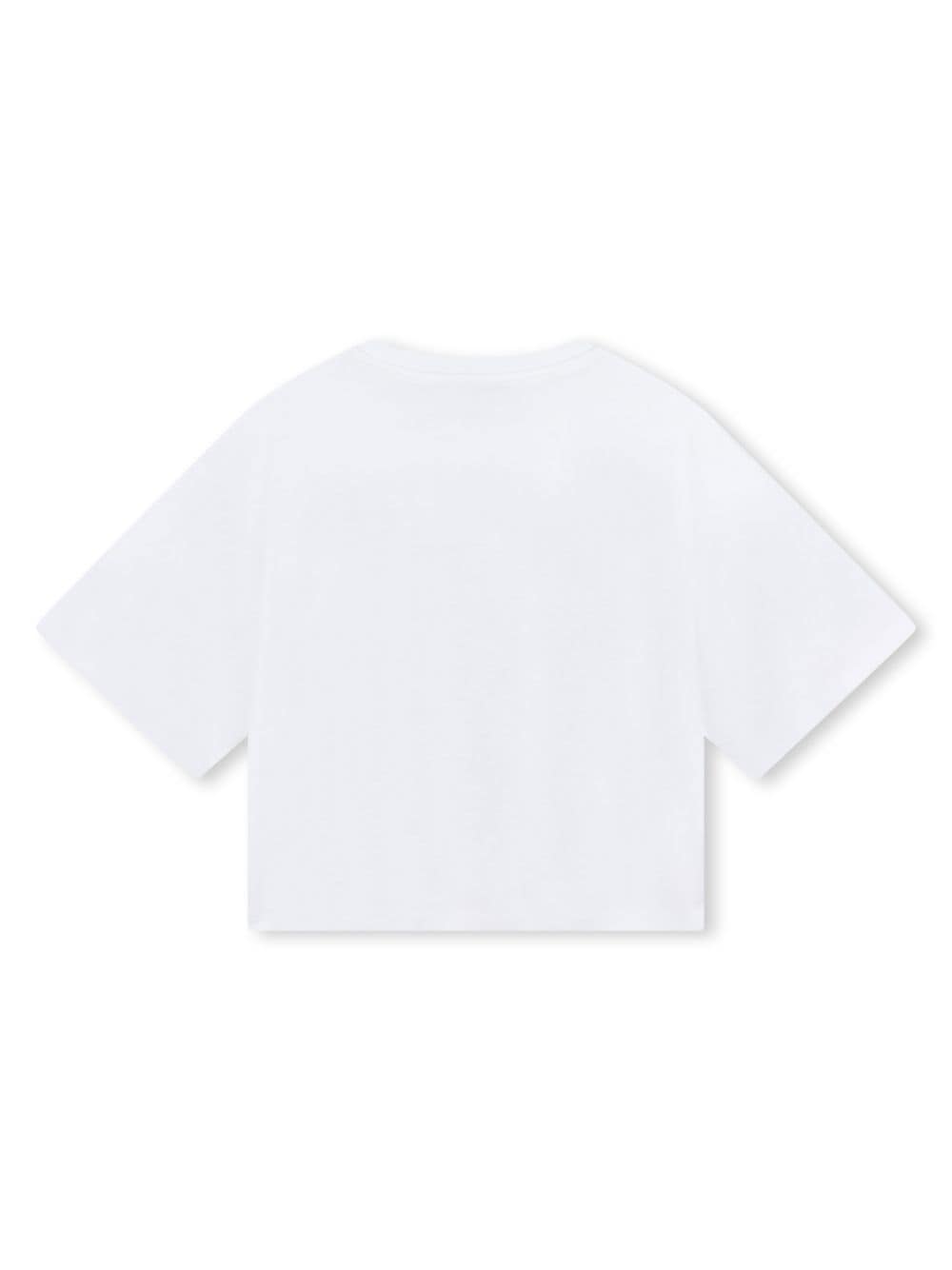 T-shirt per bambina DKNY Kids bianca con stampa logo New York City circoscritto - Rubino Kids